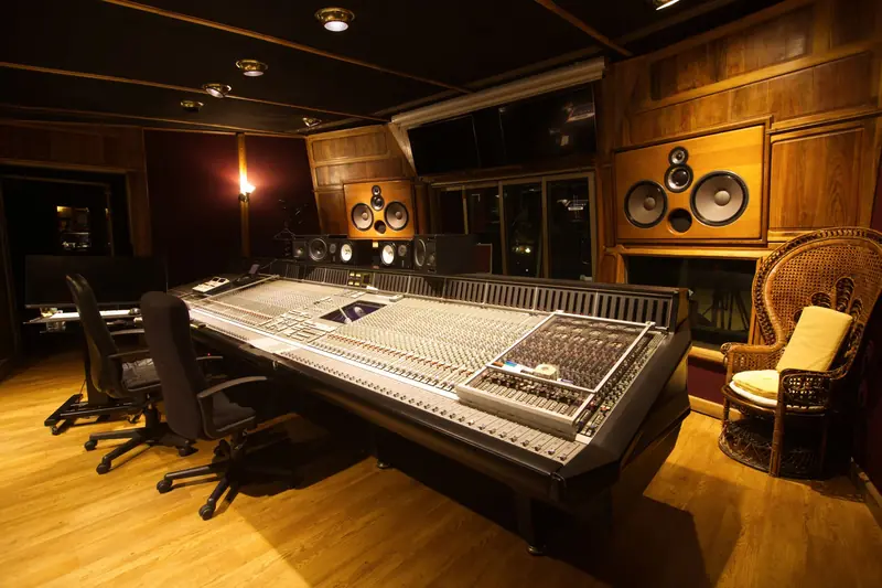 Cozy recording studio with a large mixing console and wooden interior design
