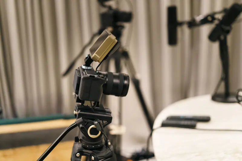 Close-up of a camera and microphone in a professional podcast studio, highlighting equipment setup